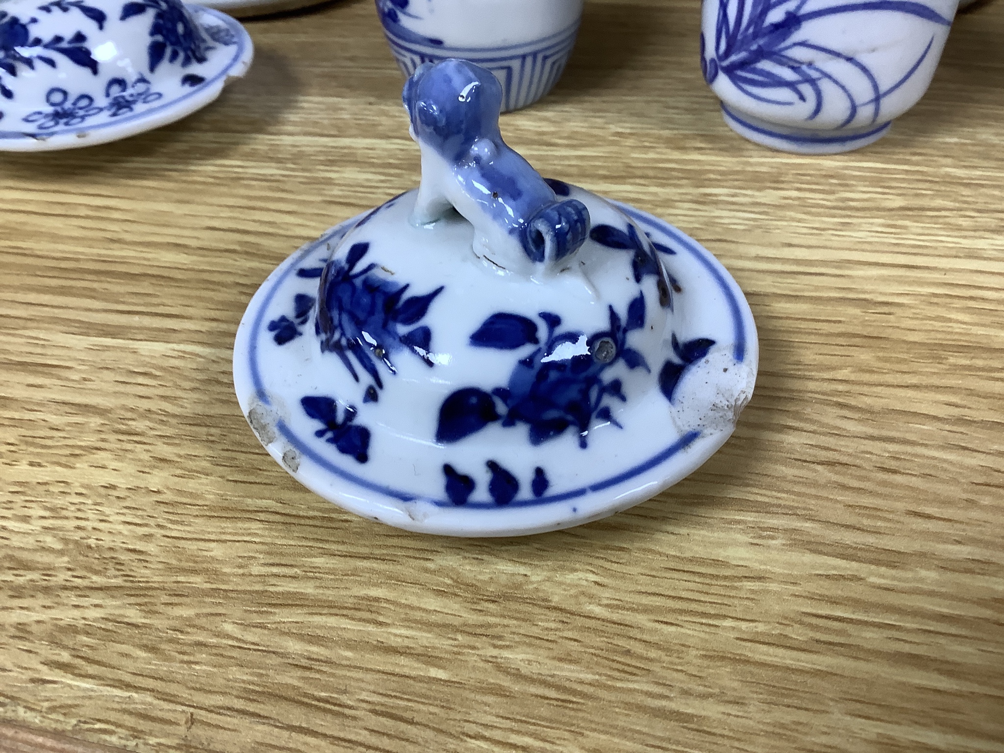 A pair of lidded Chinese blue and white vases, c.1900, Kangxi marks, 23cm high, together with two small Japanese vases, and a cup and saucer (6)